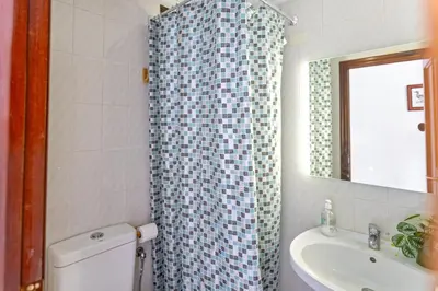 a bathroom with a toilet and a sink and a shower at ViDa MaLu - Housevanlive in Sueca