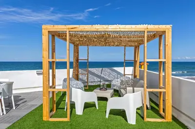 a gazebo on the roof of a house with the ocean at ViDa MaLu - Housevanlive in Sueca