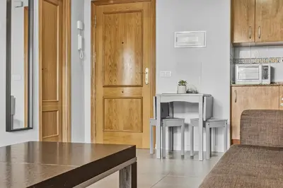 a living room with a table and a kitchen at Moncofa Vistas Mar - Ideal Parejas in Moncófar