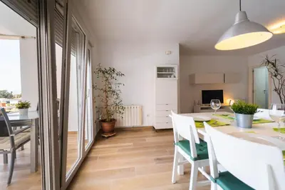 a kitchen and dining room with a table and chairs at Apartamento acogedor en la Playa de Nules in Nules