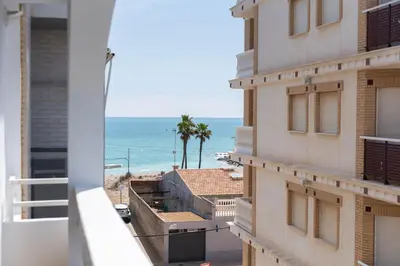 a view of the beach from the balcony of a building at Apartamento acogedor en la Playa de Nules in Nules
