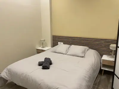 a bedroom with a white bed with a pair of shoes on it at Sensacional apartamento en Ruzafa in Valencia