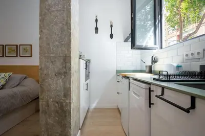 a kitchen with white cabinets and a sink and a window at Loft nuevo cerca de Ruzafa y Ciudad de las Artes in Valencia