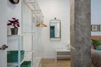 a living room with a glass shelf and a mirror at Loft nuevo cerca de Ruzafa y Ciudad de las Artes in Valencia