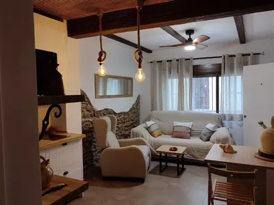 a living room with a white couch and a table at Ca Salamandra in Albalat de Taronchers