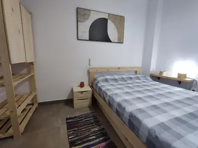a bedroom with a bed and a picture on the wall at Ca Salamandra in Albalat de Taronchers
