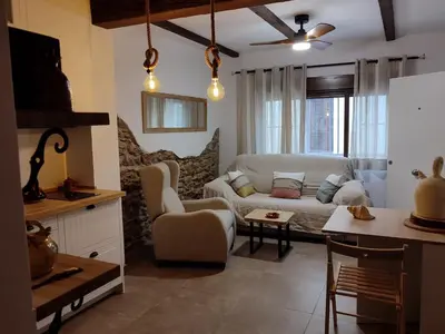 a living room with a white couch and a table at Ca Salamandra in Albalat de Taronchers