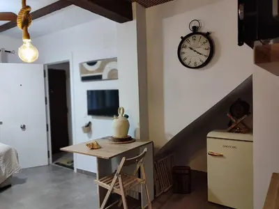 a room with a table and a clock on the wall at Ca Salamandra in Albalat de Taronchers
