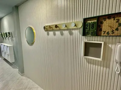 a bathroom with a clock and a mirror on a wall at Cullera Beach Oasis in Cullera