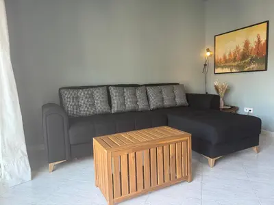 a living room with a black couch and a coffee table at Cullera Beach Oasis in Cullera