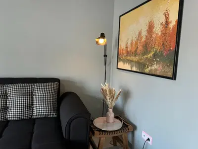 a living room with a couch and a table with a lamp at Cullera Beach Oasis in Cullera