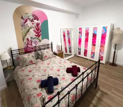 a bedroom with a bed with two crosses on it at Amplio y colorido piso in Valencia