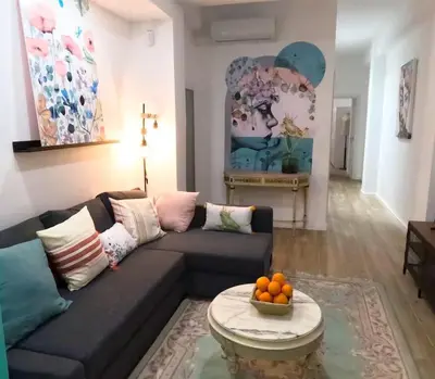 a living room with a couch and a table at Amplio y colorido piso in Valencia