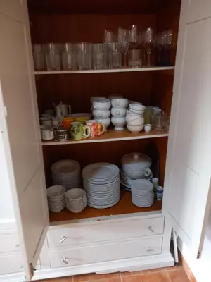a cabinet filled with plates and cups and dishes at The Villarosa in Turís