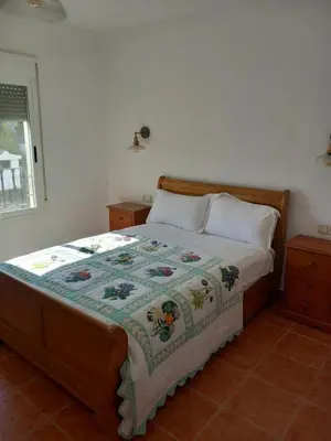 a bed with a quilt on it in a bedroom at The Villarosa in Turís