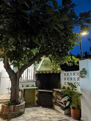 a view of a house with a patio at night at Chalet independiente con piscina in Partida de La Cañada
