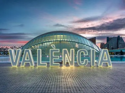 a view of a building with a blue arch at night at Chalet independiente con piscina in Partida de La Cañada