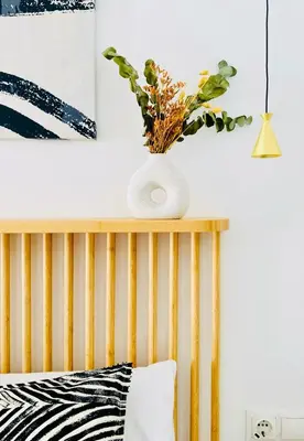a vase with a plant on top of a bed at BAJO A - Design & Comfort in Ruzafa SOHO in Valencia