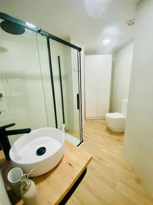 a bathroom with a white sink and a toilet at BAJO A - Design & Comfort in Ruzafa SOHO in Valencia