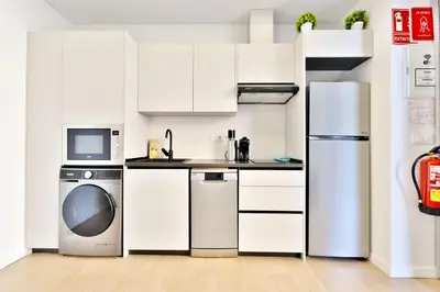 a white kitchen with a refrigerator and a dishwasher at Apartamento RD A in Valencia