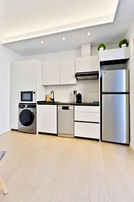 a white kitchen with white cabinets and appliances at Apartamento RD A in Valencia