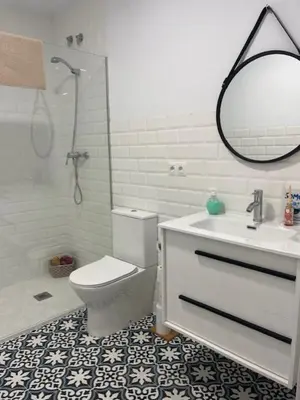 a bathroom with a toilet and a sink and a mirror at ALZIRA BONiTA LES BARRAQUES 2PAX in Alzira