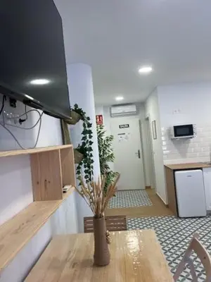 a living room with a table and a tv at ALZIRA BONiTA LES BARRAQUES 2PAX in Alzira