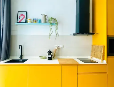 a kitchen with yellow cabinets and a sink at BAJO B - Design & Comfort in Ruzafa SOHO in Valencia