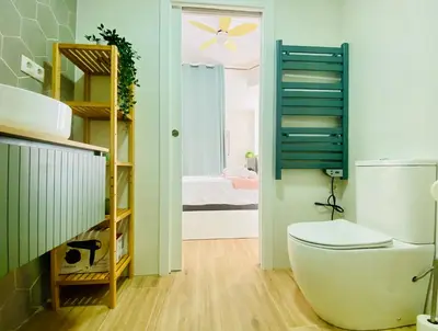 a bathroom with a toilet and a bedroom at BAJO B - Design & Comfort in Ruzafa SOHO in Valencia