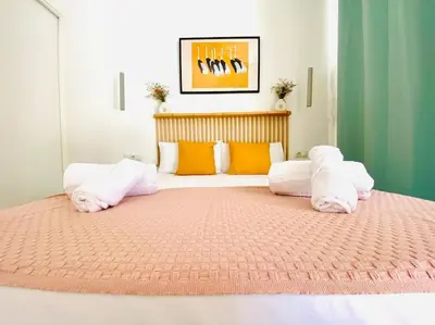 a large bed with white pillows in a bedroom at BAJO B - Design & Comfort in Ruzafa SOHO in Valencia