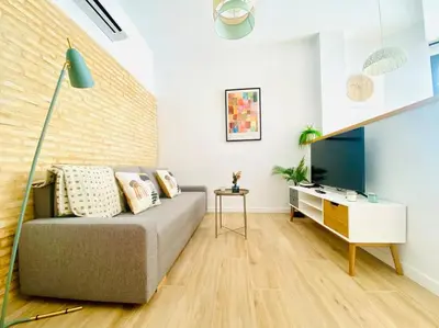 a living room with a couch and a table at BAJO B - Design & Comfort in Ruzafa SOHO in Valencia