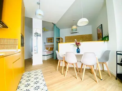 a kitchen and dining room with a table and chairs at BAJO B - Design & Comfort in Ruzafa SOHO in Valencia