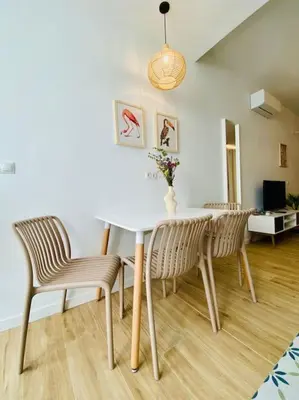 a dining room with a white table and chairs at BAJO C - Design & Comfort in Ruzafa SOHO in Valencia