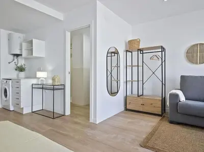 a living room with a couch and a chair at Estudio Temporal a 2' de la playa de Sagunto A2 in Puerto de Sagunto