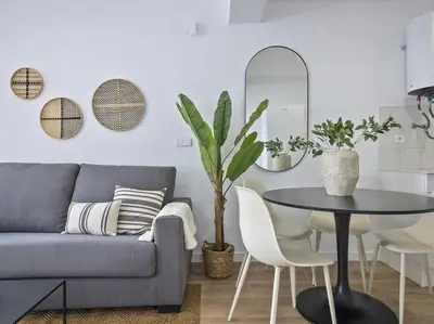 a living room with a couch and a table and chairs at Moderno estudio a 2 minutos de la Playa Sagunto A3 in Puerto de Sagunto