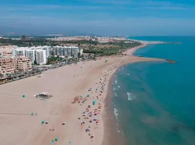 an aerial view of a beach with people and the ocean at Moderno estudio a 2 minutos de la Playa Sagunto A3 in Puerto de Sagunto