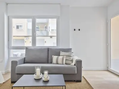 a living room with a couch and a table at Refugio Costero a 2 minutos de Playa Sagunto A4 in Puerto de Sagunto