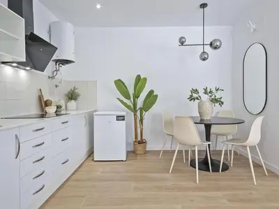 a kitchen with a table and a white refrigerator at Refugio Costero a 2 minutos de Playa Sagunto A4 in Puerto de Sagunto
