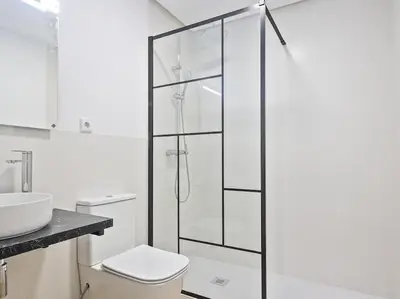 a bathroom with a toilet and a glass shower at Escondite a 2 minutos de playa de Sagunto A5 in Puerto de Sagunto