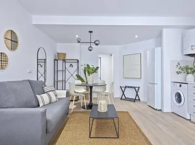 a living room with a gray couch and a table at Escondite a 2 minutos de playa de Sagunto A5 in Puerto de Sagunto
