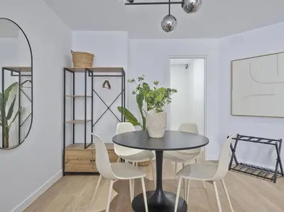 a dining room with a table and white chairs at Escondite a 2 minutos de playa de Sagunto A5 in Puerto de Sagunto