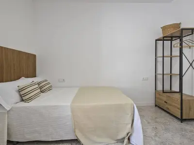 a bedroom with a bed and a book shelf at Oasis Junto al Mar a 2 minutos de playa Sagunto A6 in Puerto de Sagunto