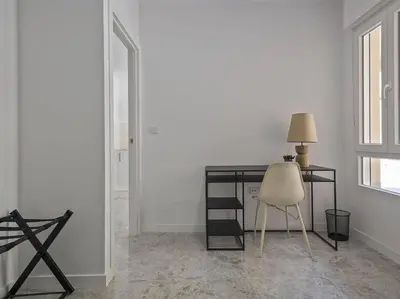 a black desk with a chair and a lamp at Oasis Junto al Mar a 2 minutos de playa Sagunto A6 in Puerto de Sagunto