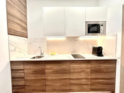 a kitchen with a sink and a microwave at Place Your Place SUITES Benimaclet in Valencia