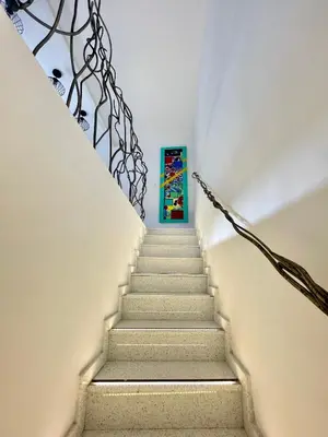a stairway leading up to a blue door at ESTUDIO CON JACCUZI Y SAUNA montaña y playa in Tavernes de Valldigna