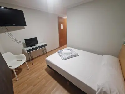 a bedroom with a bed and a desk with a laptop at Canon,che in Alcántara de Júcar