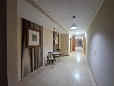 a hallway with a table and chairs in a building at Canon,che in Alcántara de Júcar