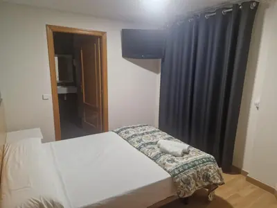 a bedroom with a bed and a black curtain at Canon,che in Alcántara de Júcar