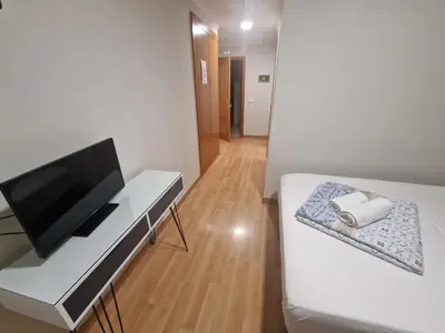a room with a bed and a desk with a television at Canon,che in Alcántara de Júcar