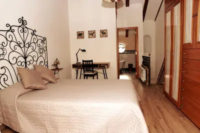 a bedroom with a large bed and a table at Casa de ensueño a 5 minutos de la playa in Valencia